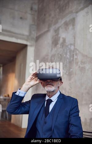 Senior businessman using VR glasses Stock Photo