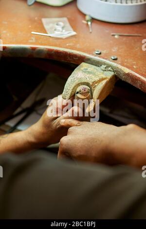 Man repairing a ring with a missing diamond Stock Photo