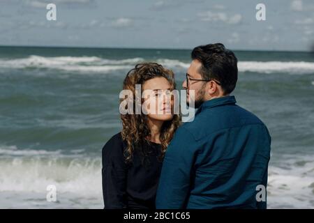 Couple standing in front of the sea Stock Photo