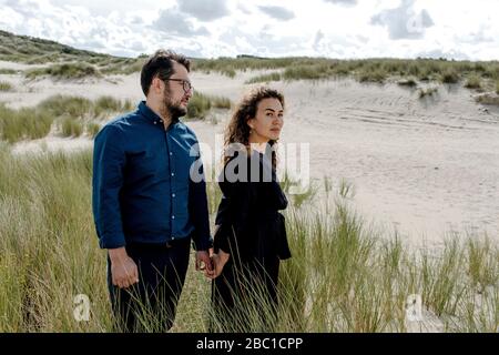 Couple walking in the dunes, The Hague, Netherlands Stock Photo