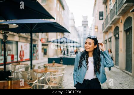 Portrait of smiling young woman in the city, Lisbon, Portugal Stock Photo