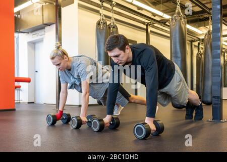 Young man and woman exercising in a gym Stock Photo