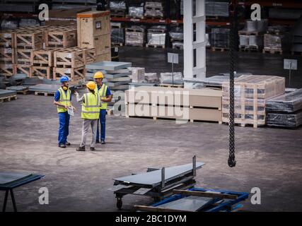 Supervisor and workers talking in warehouse Stock Photo