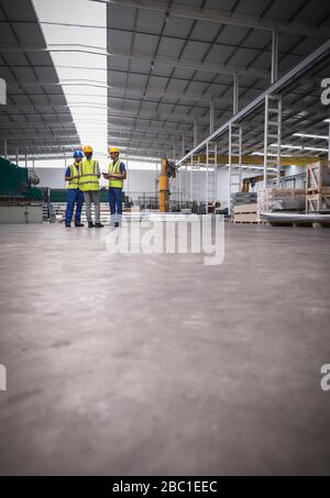 Workers talking in steel factory Stock Photo