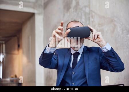 Senior businessman using VR glasses Stock Photo