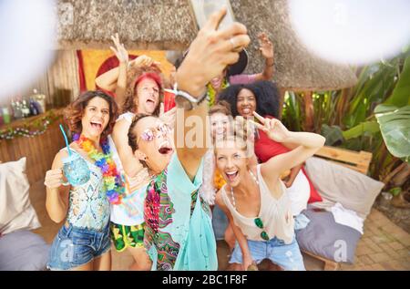 Enthusiastic young friends taking selfie at sunny summer poolside Stock Photo