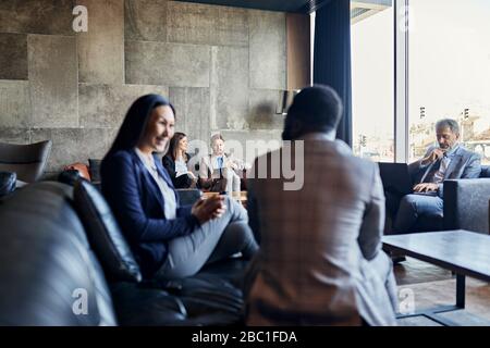Business people having a meeting in hotel lobby Stock Photo