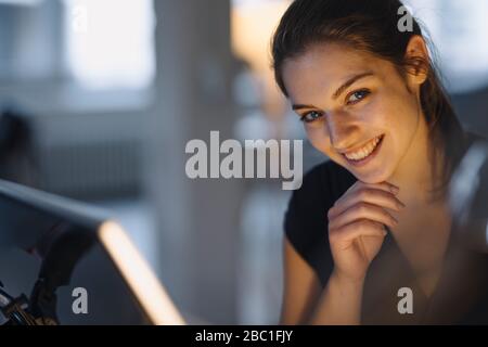 Portrait of happy young businesswoman in office Stock Photo