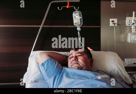 Patient lying in hospital bed Stock Photo