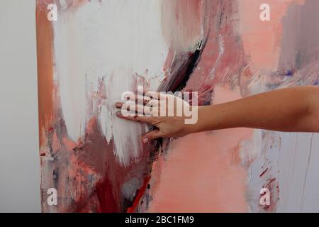 Hand of a female painter on her painting Stock Photo