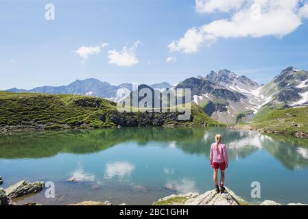 Switzerland, St Gallen Canton, Glarus Alps, Woman looking at Wangs Lake Stock Photo