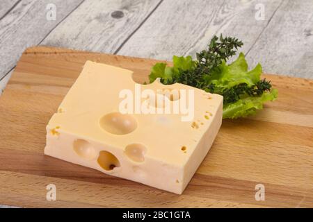 Maasdam cheese brick with thyme branch Stock Photo