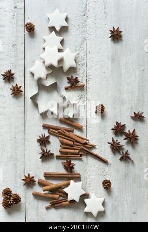 Star shaped cookies, cinnamon sticks, pine cones, cookie cutters and star anise Stock Photo