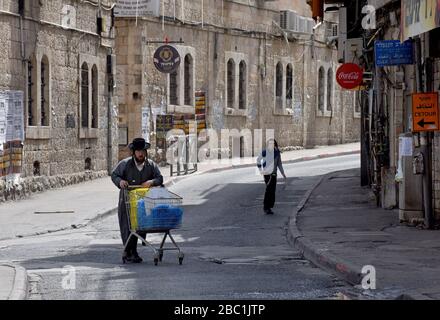 Jerusalem, Israel. 02nd Apr, 2020. An Ultra-Orthodox Jew pushes a grocery cart in the Mea Shearim neighborhood in Jerusalem, on Thursday, April. 2, 2020. The cases of coronavirus has jumped in Israeli Ultra-Orthodox cities, amid growing concerns of a major outbreak of COVID-19 in the religious communities. Photo by Debbie Hill/UPI Credit: UPI/Alamy Live News Stock Photo