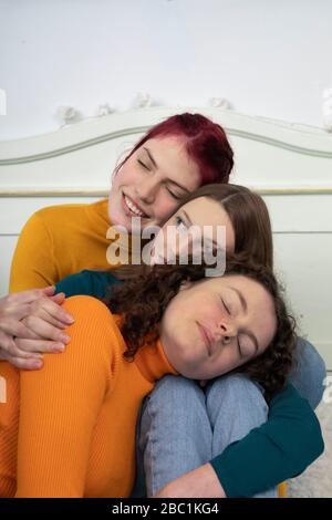 Portrait of three sisters cuddling together Stock Photo