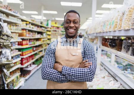 Portrait confident, smiling male grocer working in supermarket Stock Photo