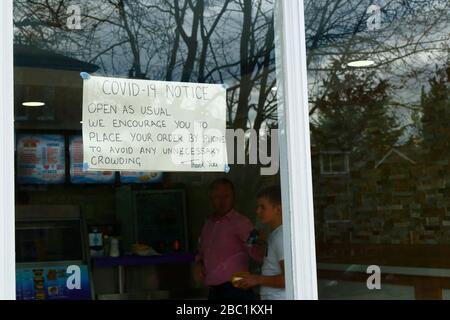 2nd April 2020, Southborough, Kent, UK: Notice encouraging people to order by phone to avoid unnecessary crowding in window of a fast food takeaway shop during the government imposed quarantine / lockdown to reduce the spread of the coronavirus. Stock Photo