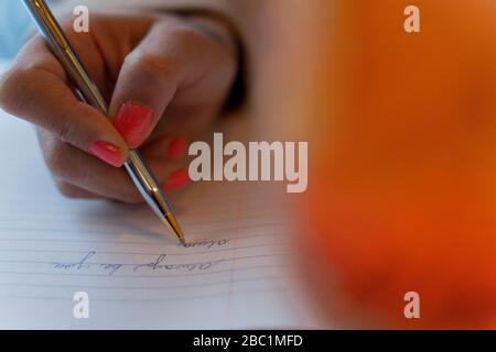 Close-up of woman taking notes Stock Photo