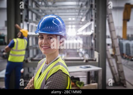 Portrait smiling, confident female worker in factory Stock Photo