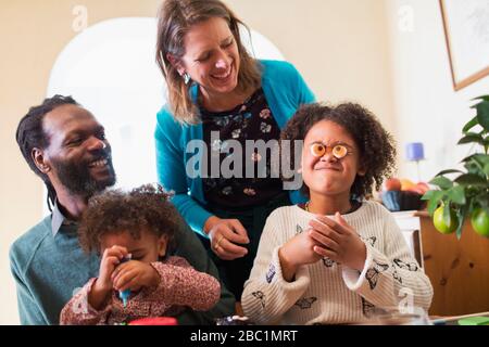 Playful family decorating cupcakes Stock Photo