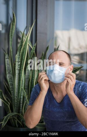 Man wearing facial disposable mask to avoid viral infection. Virus protection Stock Photo