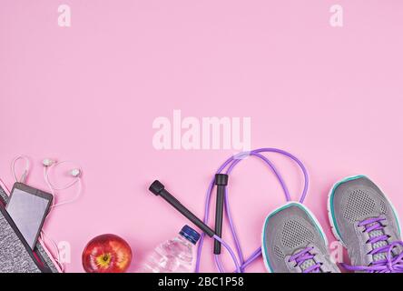 Fitness sports equipment and accessories on pink background, flat lay with copy space. Home online workout, run or yoga exercise. Weight loss concept during quarantine Stock Photo