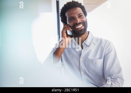 Smiling businessman talking on cell phone Stock Photo