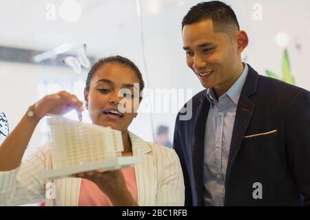 Architects discussing model in office Stock Photo