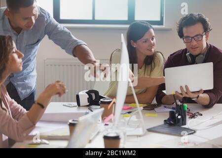 Computer programmers programming virtual reality simulator glasses in office Stock Photo