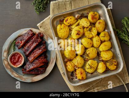 Barbecue pork ribs and crushed smashed potatoes. Slow cooking recipe. Stock Photo