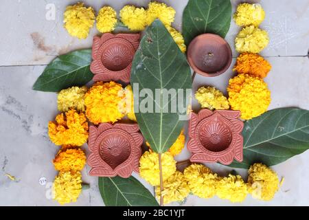 Swastika made using Marigold flowers for Ugadi with Clay Oil Lamp Stock Photo