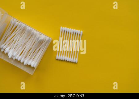 Flat lay composition with cotton swabs on yellow background. Top view Stock Photo
