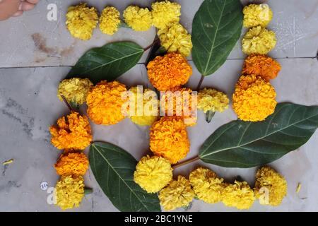 Swastika made using Marigold flowers for Ugadi with Clay Oil Lamp Stock Photo