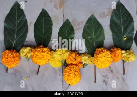 Swastika made using Marigold flowers for Ugadi with Clay Oil Lamp Stock Photo