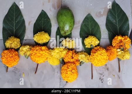 Swastika made using Marigold flowers for Ugadi with Clay Oil Lamp Stock Photo