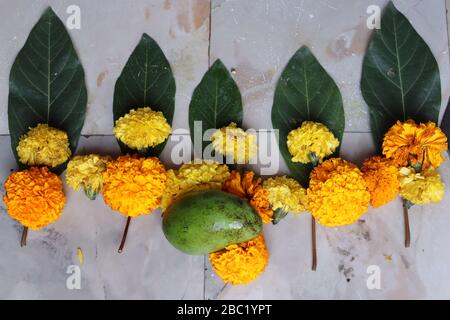 Swastika made using Marigold flowers for Ugadi with Clay Oil Lamp Stock Photo