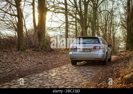 Poratz, Brandenburg, Germany - march 11, 2018: a Mazda car driving on a cobbled street to the hamlet Poratz in Brandenburg Stock Photo