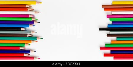 Colorful pencils on white background. Top view, copy space Stock Photo