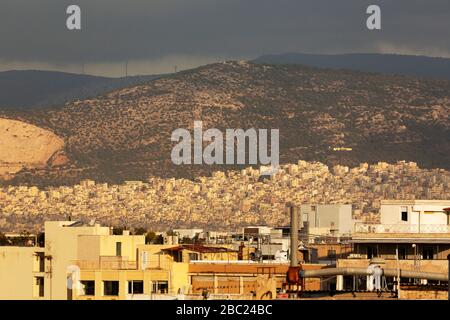 Buildings in Athens, Greece. Dark clouds hang over the city. Stock Photo