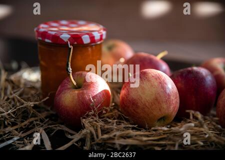 Fresh apples in front of a jar of compote Stock Photo