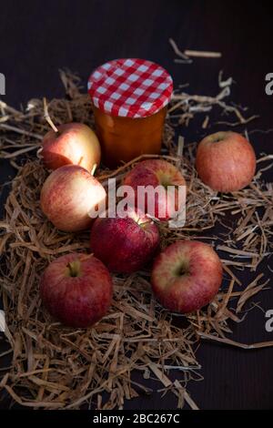 Fresh apples in front of a jar of compote Stock Photo