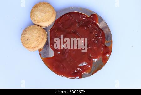 red ketchup splashes  with biscutis isolated on white background Stock Photo