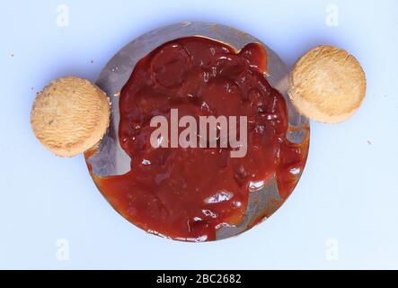 red ketchup splashes  with biscutis isolated on white background Stock Photo
