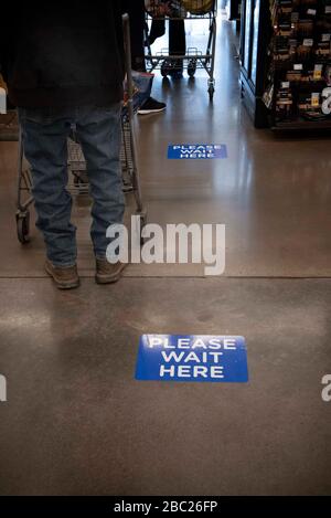 Roswell, GA, USA. 2nd Apr, 2020. A sign newly affixed to Kroger supermarket store floors advising customers to keep a safe distance from others during Covid-19 coronavirus pandemic. Credit: Robin Rayne/ZUMA Wire/Alamy Live News Stock Photo