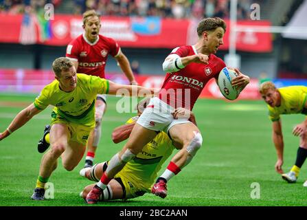 Vancouver, Canada. 8th March, 2020. Lucas Hammond #7 of Canada tackled by Australia players in Match #40 (Cup Semi Final) during Day 2 - 2020 HSBC Wor Stock Photo