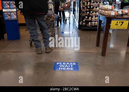 April 2, 2020, Roswell, Georgia, USA: A sign newly affixed to Kroger supermarket store floors advising customers to keep a safe distance from others during Covid-19 coronavirus pandemic. (Credit Image: © Robin Rayne/ZUMA Wire) Stock Photo