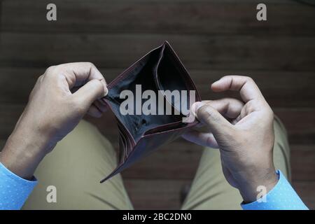 Empty wallet in the hands of an young man Stock Photo