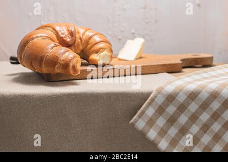 Croissant, butter for breakfast. Breakfast on a rustic table. A rural meal. Bakery products. Polish pastries. Stock Photo