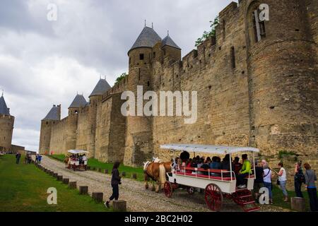 Tourists on the Horse Wagon Tour around Carcassonne Castle Aude France Stock Photo