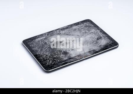 Tablet isolated on white background. The glass of the touchscreen is broken. Stock Photo